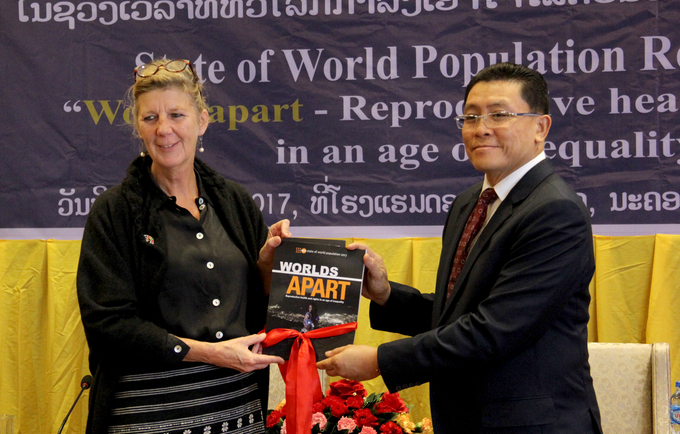 UNFPA Representative in Lao PDR hands the State of World Population 2017 report over to Vice Minister, Ministry of Planning and Investment